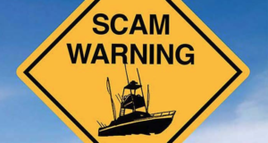 Yellow Diamond street sign with words, "Scam Warning" and photo of boat.